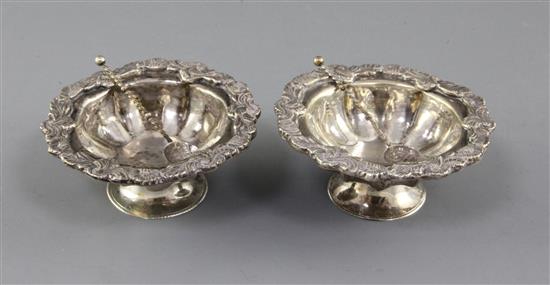A pair of late 19th century Russian? silver circular salts with two spoons, 6 oz.